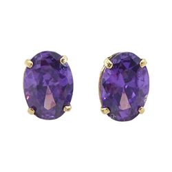 Pair of 9ct gold oval cut amethyst stud earrings, stamped