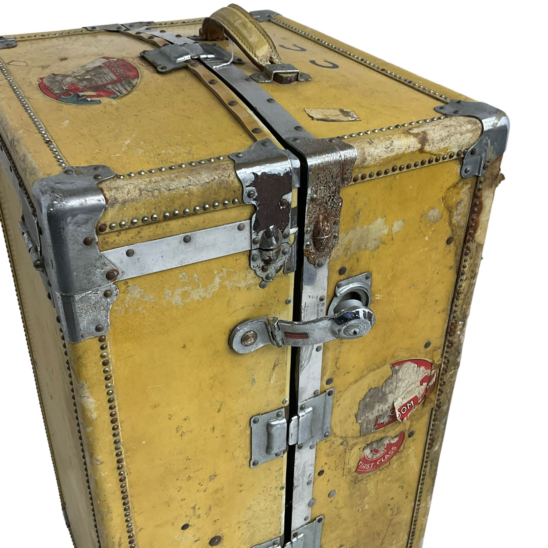 Early 20th century steamer traveling trunk, in yellow finish with chrome fixtures, the interior fitted with drawers and hangers, with various travel labels 