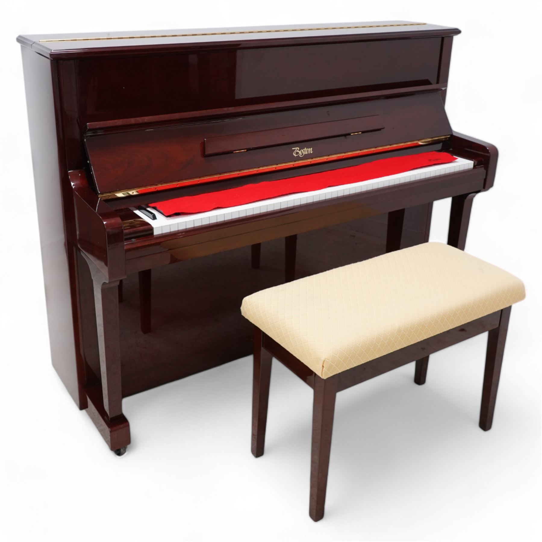 Boston - Upright overstrung piano in a lacquered mahogany case, designed by Steinway and manufactured by Kawai in Japan, Model 118E, serial No 131623 (1999), with 88 synthetic ivory/ ebony keys (seven octaves) with mute, una-corda and sustain pedals, original nickel plated tuning pins, hammers, strings and damper felts. With matching duet stool.