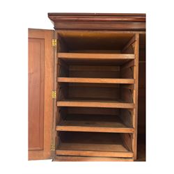 Victorian mahogany linen-press, moulded cornice over two figured panelled doors, the interior fitted with five slides and hanging rail, four long drawers below 