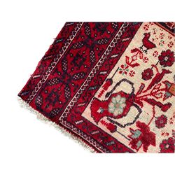 Persian Baluchi dark indigo and crimson ground rug, the field decorated with rows of repeating Pitrak motifs and surrounded by small bird and flower head motifs, floral urn decorated spandrels, repeating Pitrak border within guard stripes