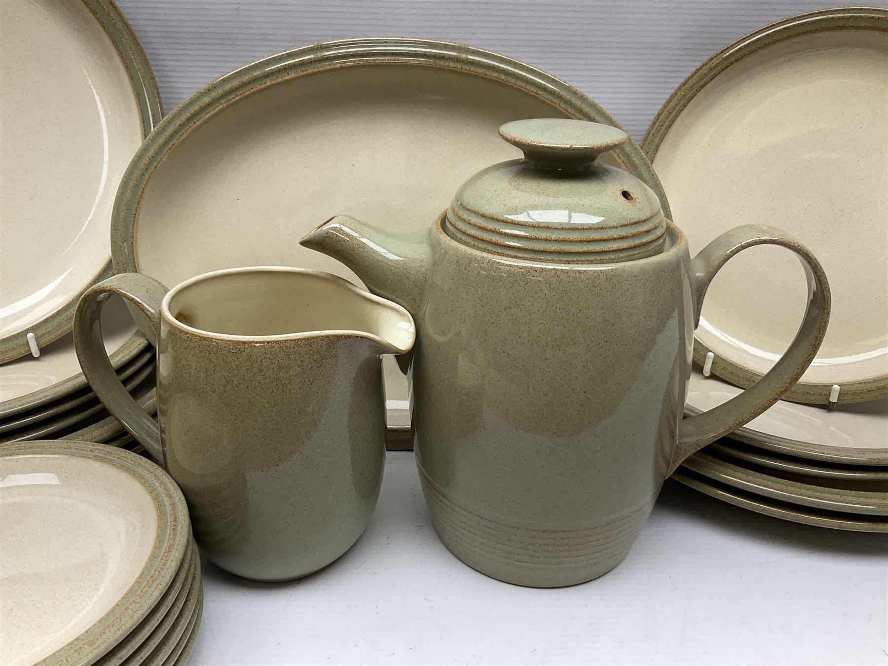 Denby tea and dinner wares, including bowls, jugs, tureens, side plates, dinner plates, serving dishes, cups and saucers, coffee pot, etc, all decorated with a green and brown mottled glaze, with printed marks beneath, in two boxes 