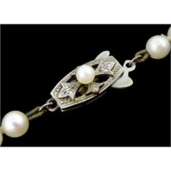 Mikimoto single strand graduating cultured pearl necklace, on original silver clasp, stamped, with guarantee and pouch