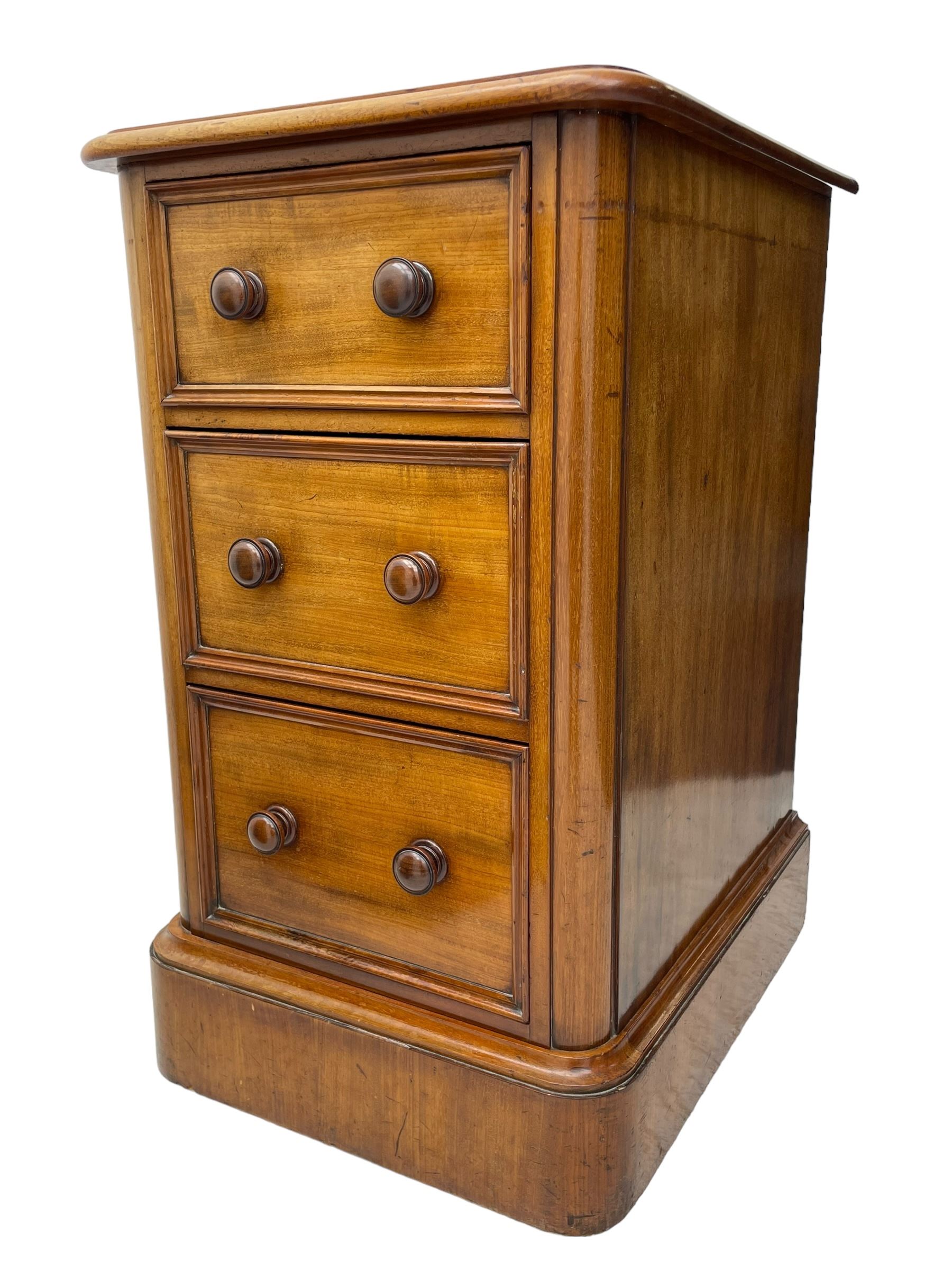 Pair of Victorian figured mahogany pedestal chests, rectangular form with rounded front corners, moulded top over three drawers with applied mouldings and turned handles, on moulded plinth base