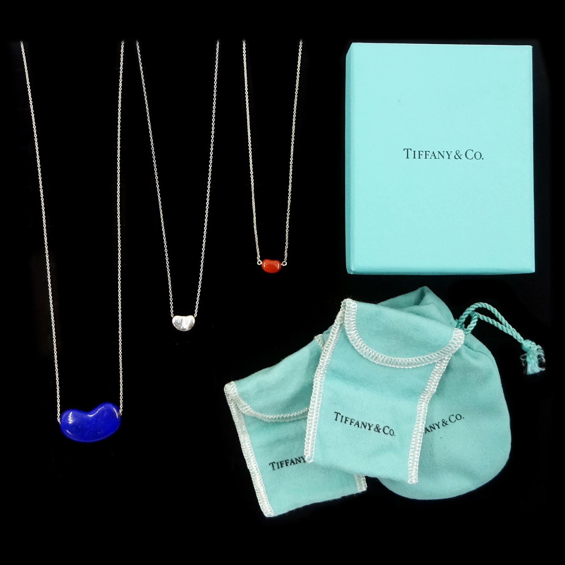 Tiffany & Co three silver Bean pendant necklaces by Elsa Peretti, including large lapis lazuli, smaller silver and jasper