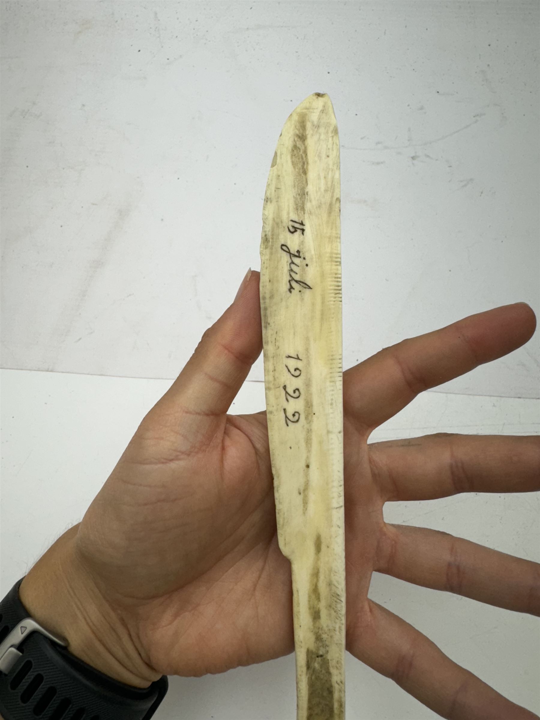 Inuit scrimshaw carved bone scraping knife, decorated with deer and tree, L25cm