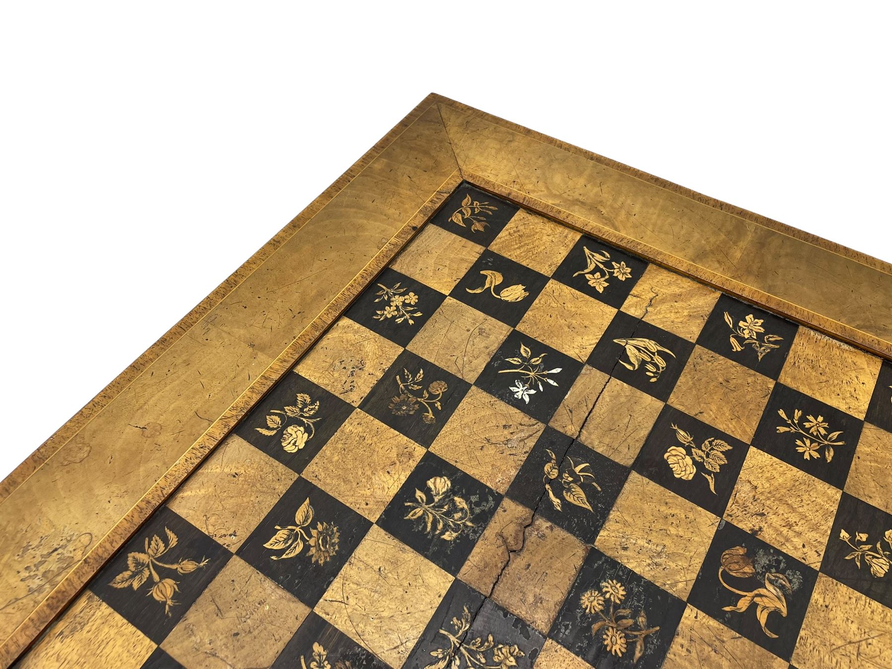 Late 19th century walnut games table, the square top with sunken inlaid chessboard decorated with inlaid floral bouquets, shaped and pierced frieze rails, on quadruple spiral turned pillars, concaved square platform inlaid with flowers, on acanthus leaf carved splayed supports with scrolled terminals 