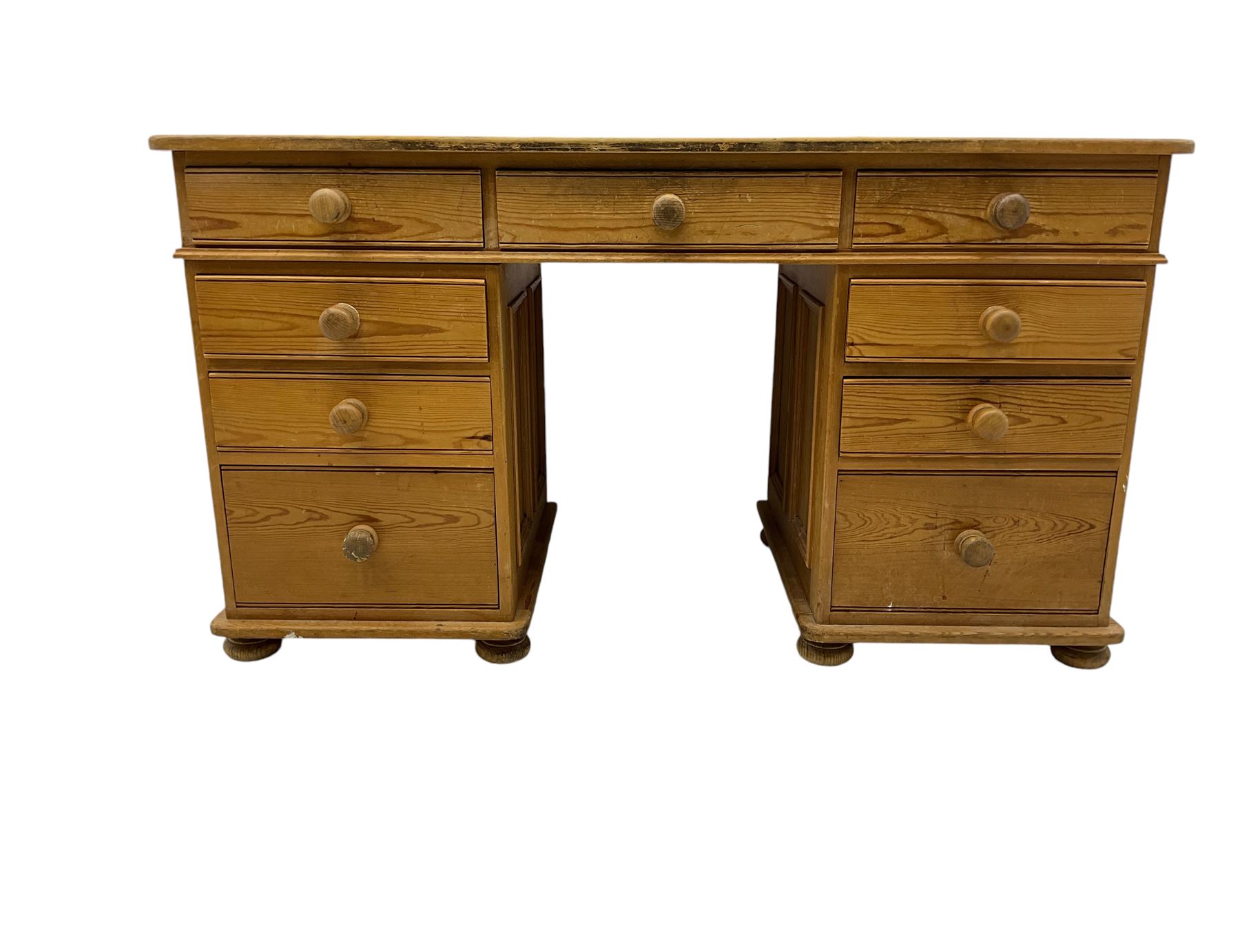 Waxed pine twin pedestal desk, rectangular top over nine drawers, on compressed bun feet 