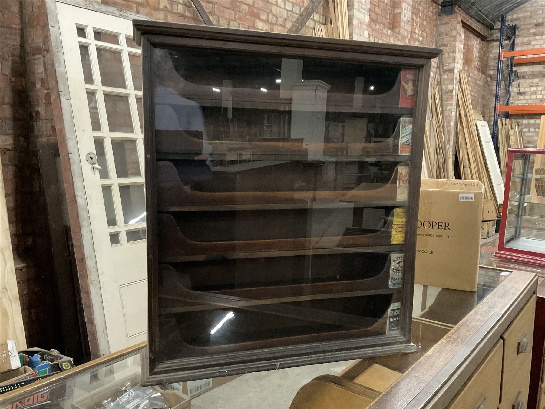 Early 20th stained pine and glazed wall mounting cigarette shop display cabinet, fitted with six sliding drawers with divisions and scalloped handles  - THIS LOT IS TO BE COLLECTED BY APPOINTMENT FROM THE OLD BUFFER DEPOT, MELBOURNE PLACE, SOWERBY, THIRSK, YO7 1QY