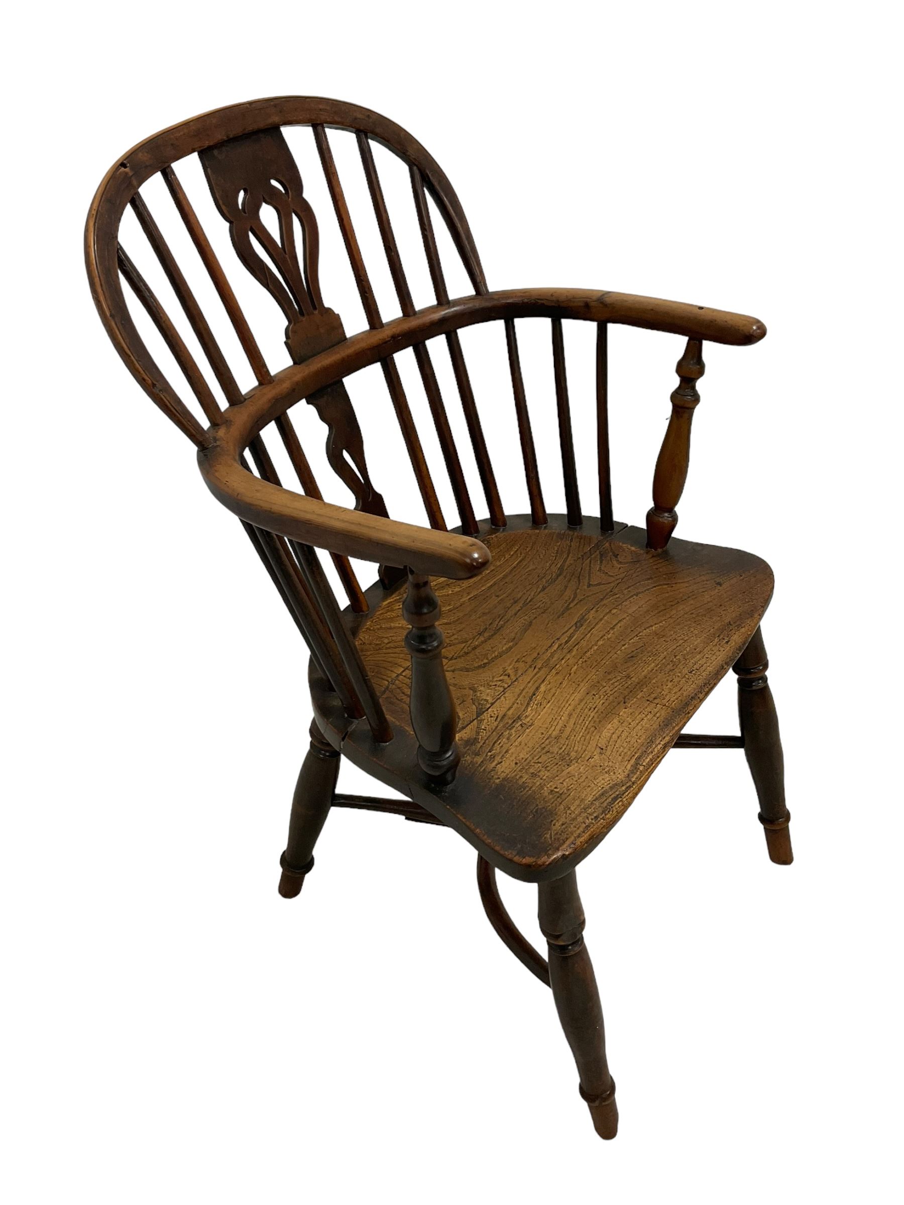 19th century yew wood and elm Windsor chair, low hoop stick back with pierced splat, dished seat raised on ring turned supports joined by crinoline stretcher