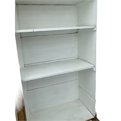 Georgian stripped pine bookcase display cabinet, plain moulded cornice over two glass-panel doors with multiple panes, enclosing white painted interior with three shelves, raised on square supports