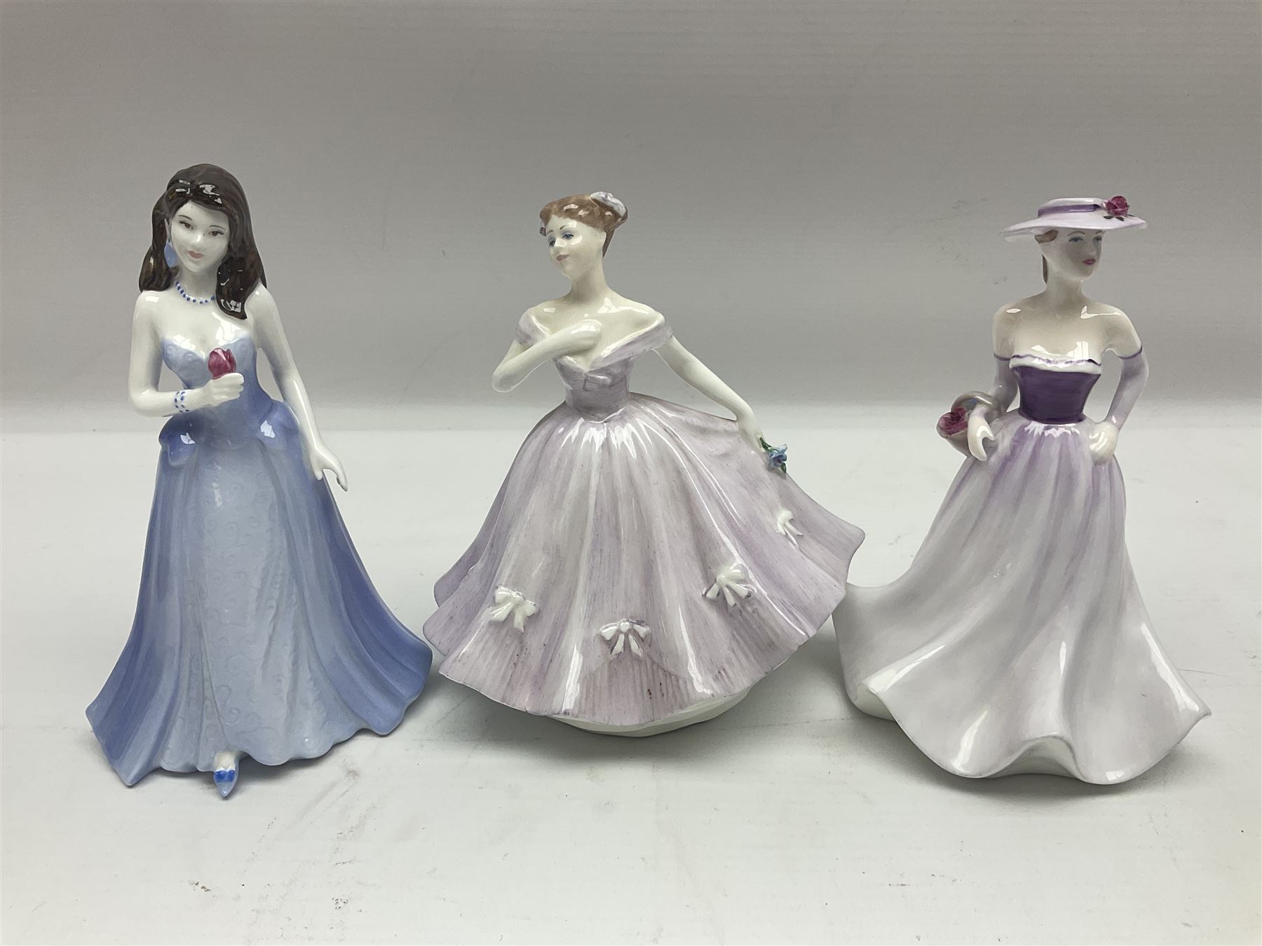 Three Royal Doulton figures, comprising Anna HN4391, Kirsty HN2381 and Deborah HN4468, together with a similar Coalport figure and ten smaller Coalport figures (14)