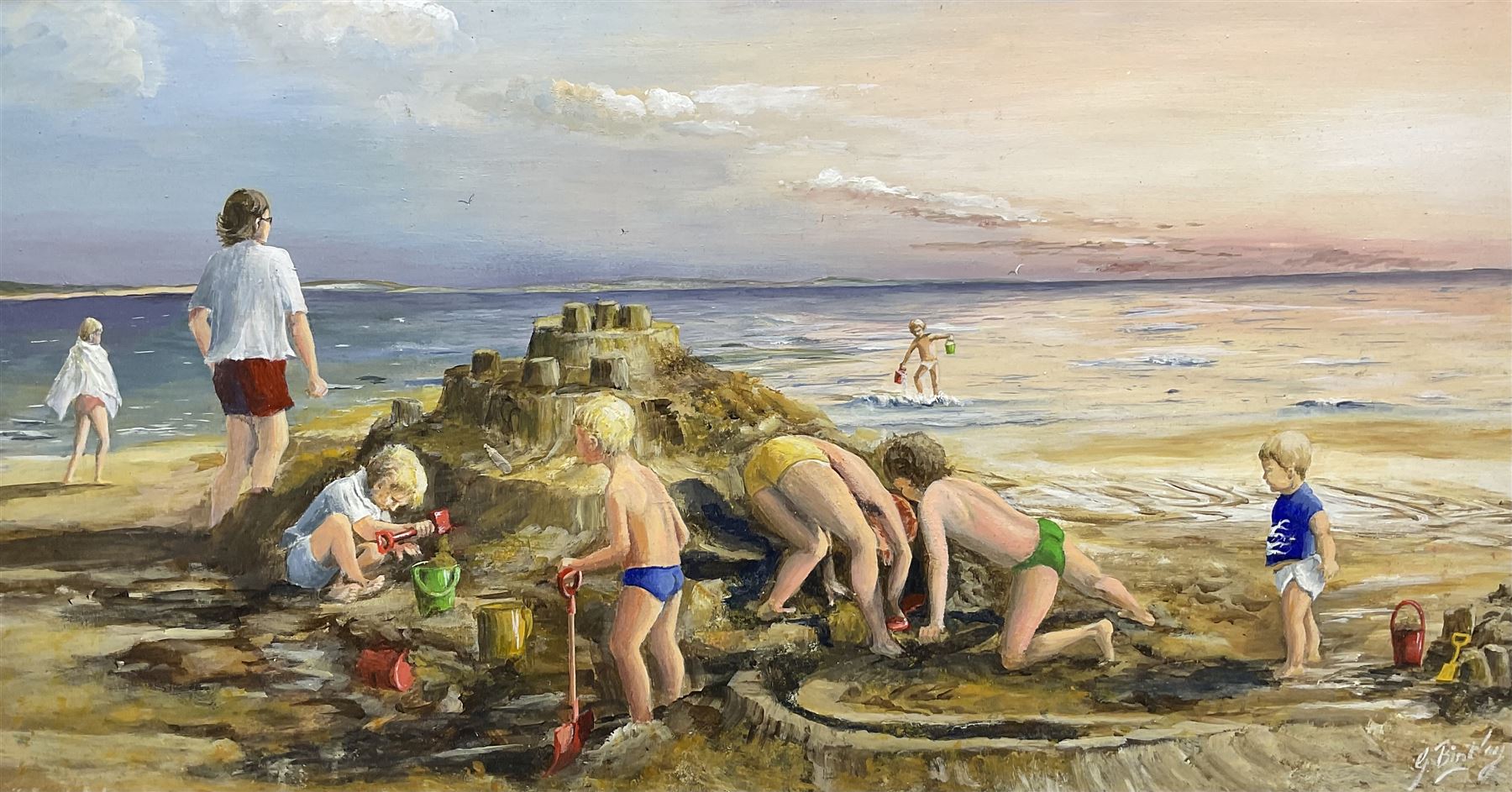 Glenys Bintley (Northern British 20th Century): Children Building a Sandcastle, oil on board signed, artists address label verso 34cm x 64cm