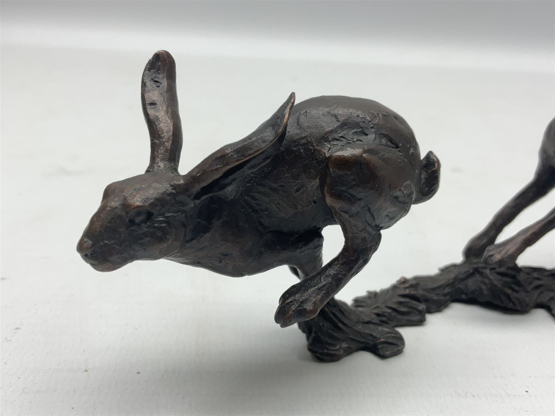 Michael Simpson: bronze Small Hares Running, modelled as three hares, limited edition 29/350, with certificate, H11cm 