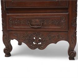 19th century French walnut hall cupboard, the frieze carved with a bouquet of flowers and trailing foliate decoration, enclosed by single panelled door over single drawer, the curved outer corners decorated with trailing leafy branches and flower heads, shaped apron with scroll carved cabriole feet 