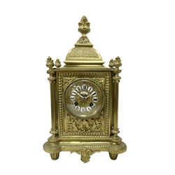 French - Brass cased 8-day mantle clock c1880, with a domed top surmounted by a pineapple finial, four reeded pilasters to the corners and raised on tapered feet, with a conforming dial with cartouche numerals, fleur-di -Lis hands and the name, Phillippe, 66 Palais Royal, Paris, twin train countwheel striking movement sounding the hours and half-hours on a bell.  With pendulum and key. 
