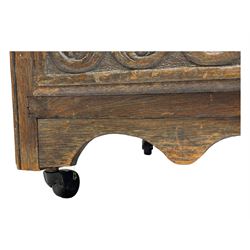 Victorian carved oak kneehole desk, the rectangular top with carved edge, above central drawer with carved front and brass handles, central kneehole with cupboard door, flanked by two banks of three graduating drawers each with similarly carved decoration, on shaped plinth base with castors