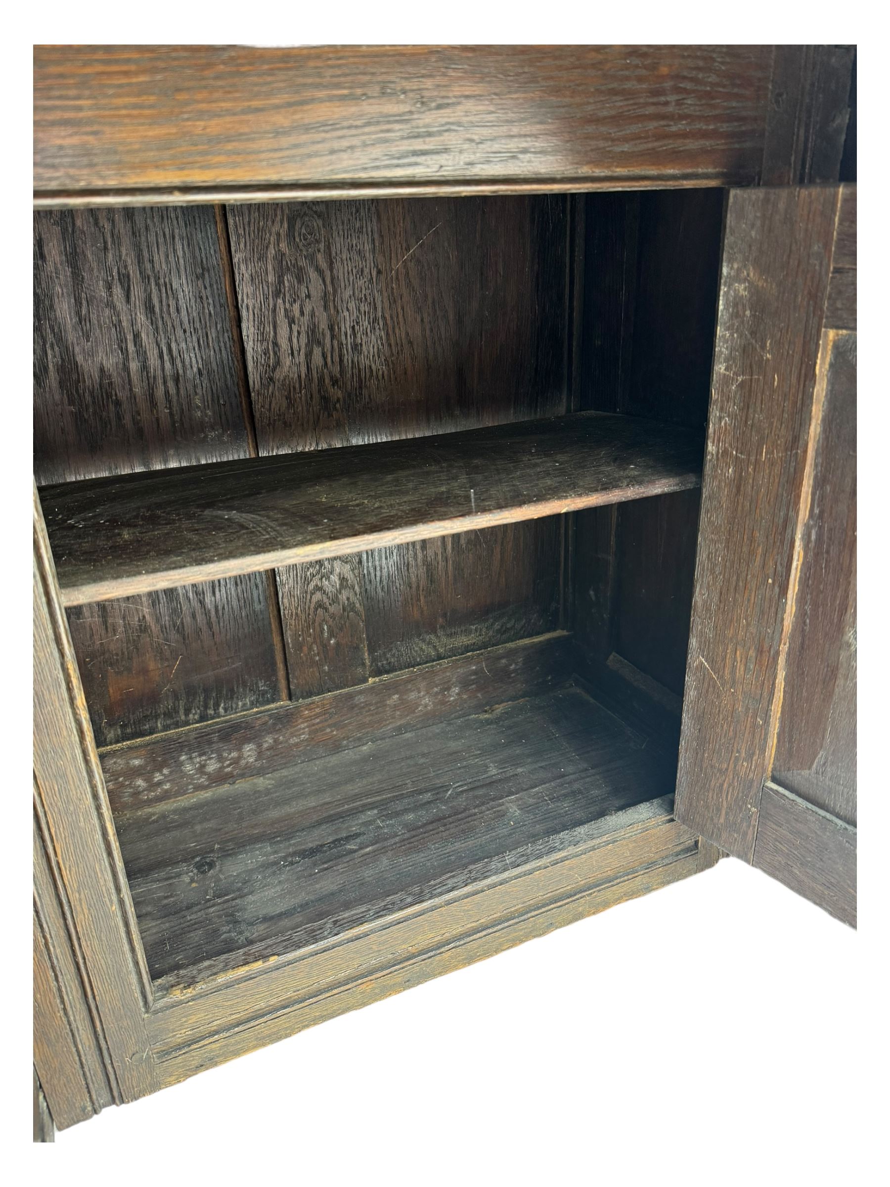 Victorian carved oak kneehole desk, the rectangular top with carved edge, above central drawer with carved front and brass handles, central kneehole with cupboard door, flanked by two banks of three graduating drawers each with similarly carved decoration, on shaped plinth base with castors