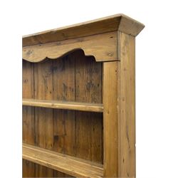 Waxed pine 'chicken coop' or 'hutch' dresser, projecting cornice over shaped frieze and three tier plate rack, the stepped waterfall lower section fitted with two slatted chicken coops, on sledge feet 