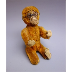  Early 20th century small plush covered figure of a monkey wearing spectacles, jointed limbs and nodding head operated by wirework tail H12cm  