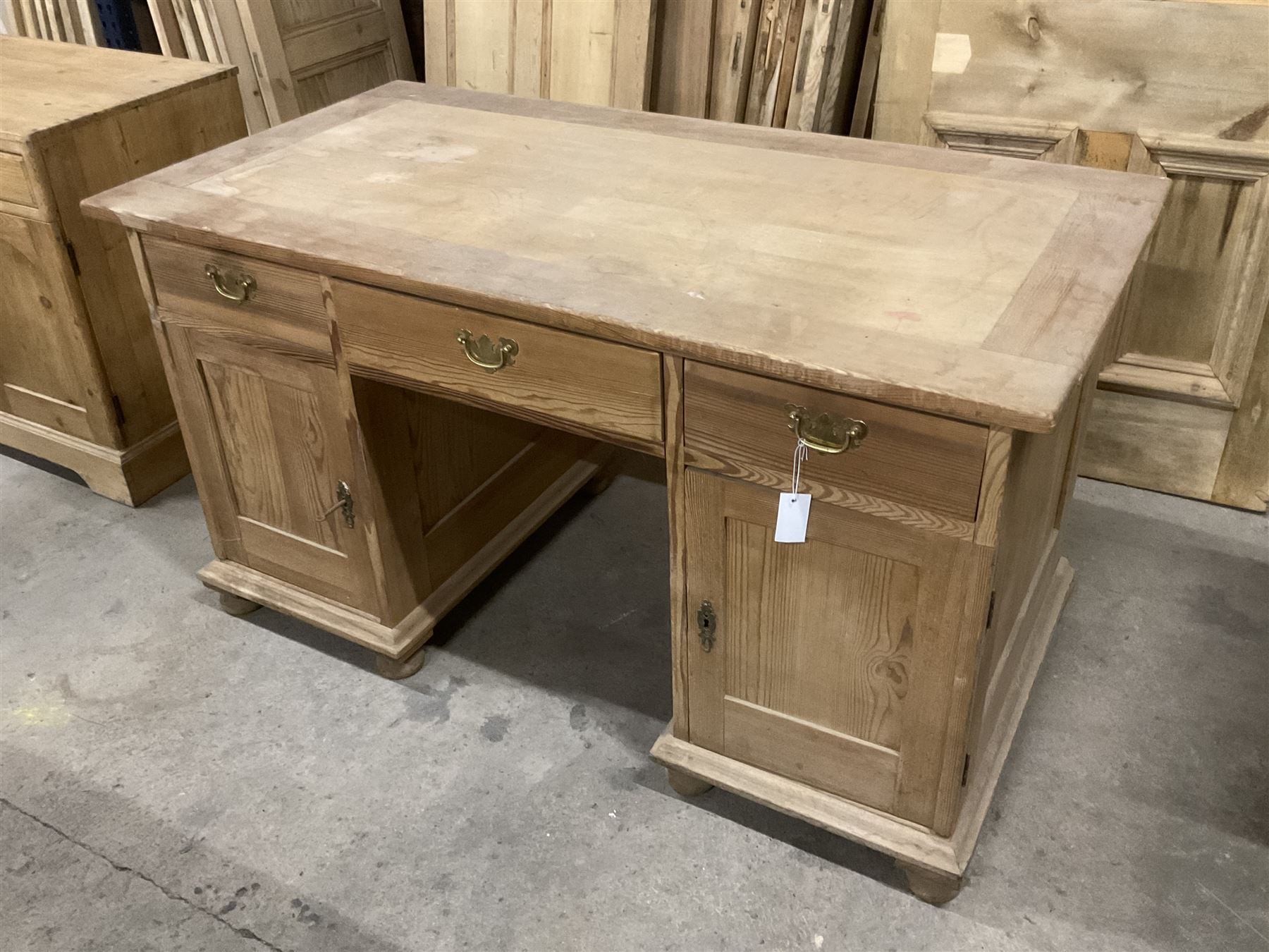 20th century pine twin pedestal desk, rectangular top over three drawers and two cupboards, enclosed by panelled doors, on turned feet - THIS LOT IS TO BE COLLECTED BY APPOINTMENT FROM THE OLD BUFFER DEPOT, MELBOURNE PLACE, SOWERBY, THIRSK, YO7 1QY