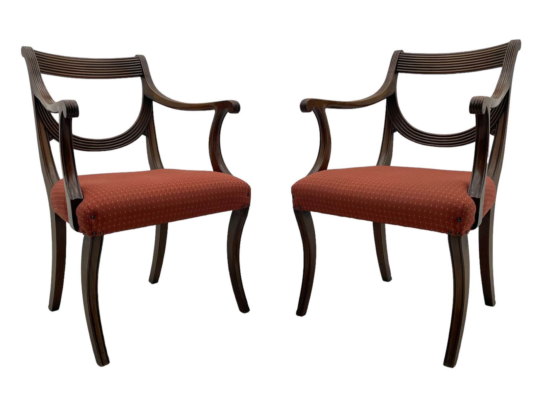 Set of six (4+2) George III design mahogany dining chairs, curved reed moulded bar back over curved and reeded middle rail, upholstered in red fabric with repeating pattern, on moulded sabre supports 