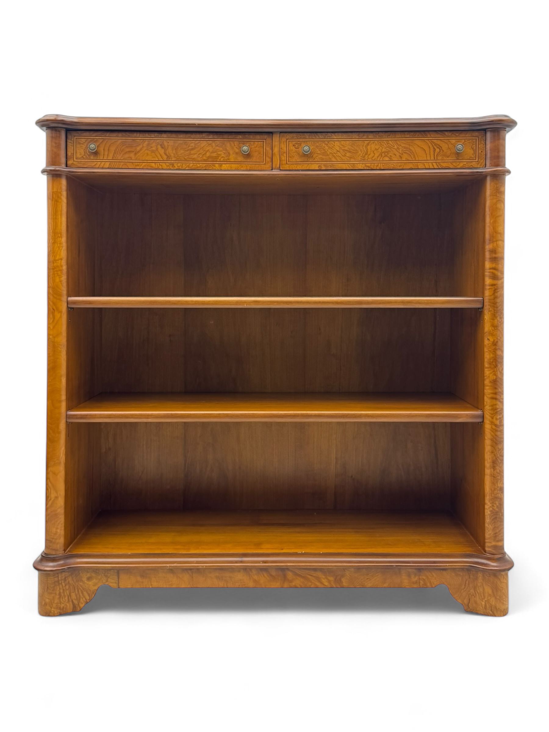 Figured walnut open bookcase, moulded top over two drawers and two shelves, on plinth base 