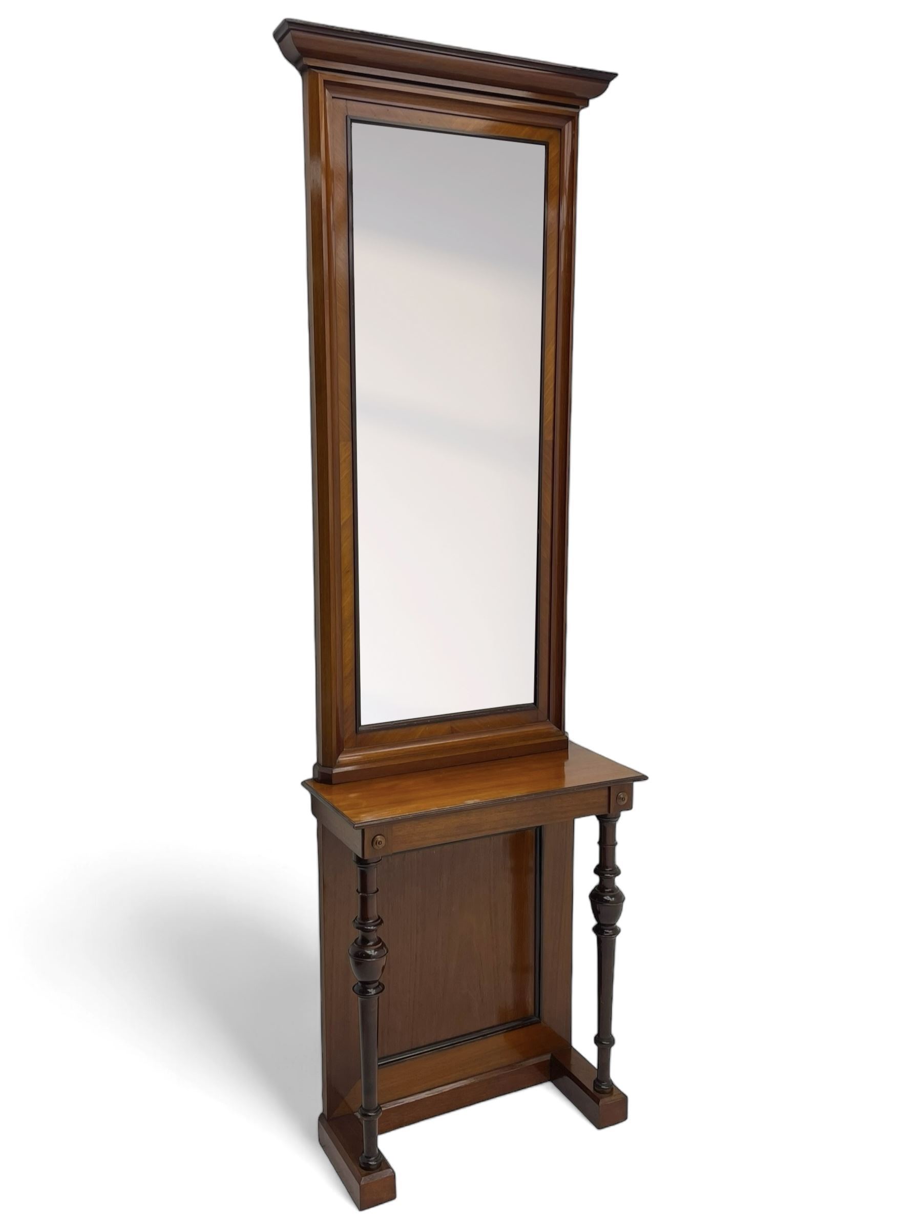 Late 19th to early 20th century walnut hallway console table with pier mirror, tall rectangular mirror with ovolo-moulded cornice, plain mirror plate surrounded by moulded slip and crossbanding, rectangular top over panelled back supports by turned supports, on sledge feet 