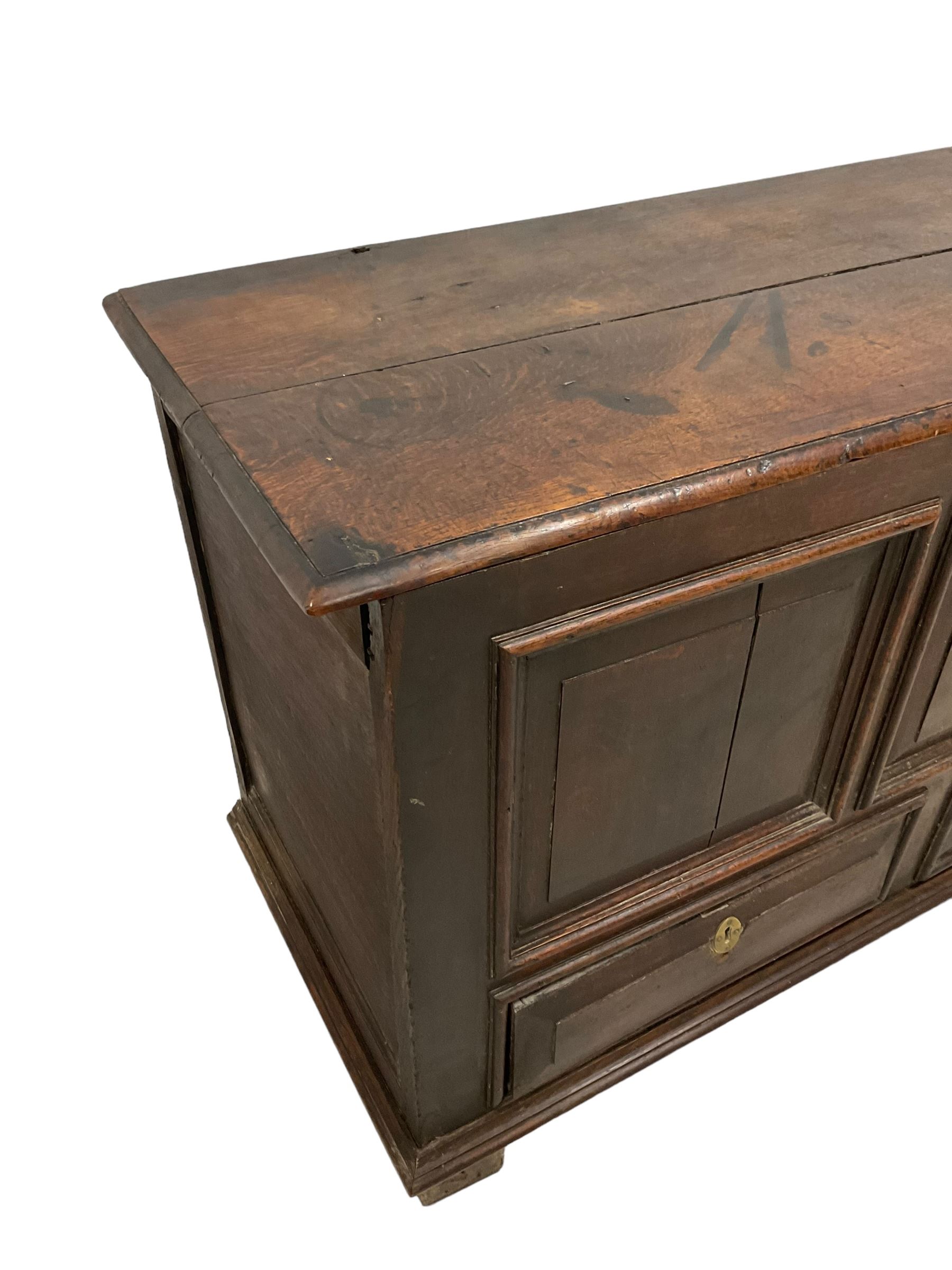 18th century oak mule chest, rectangular hinged top with moulded edge enclosing candle box, triple panelled font over two drawers with fielded panelled facias, on stile supports