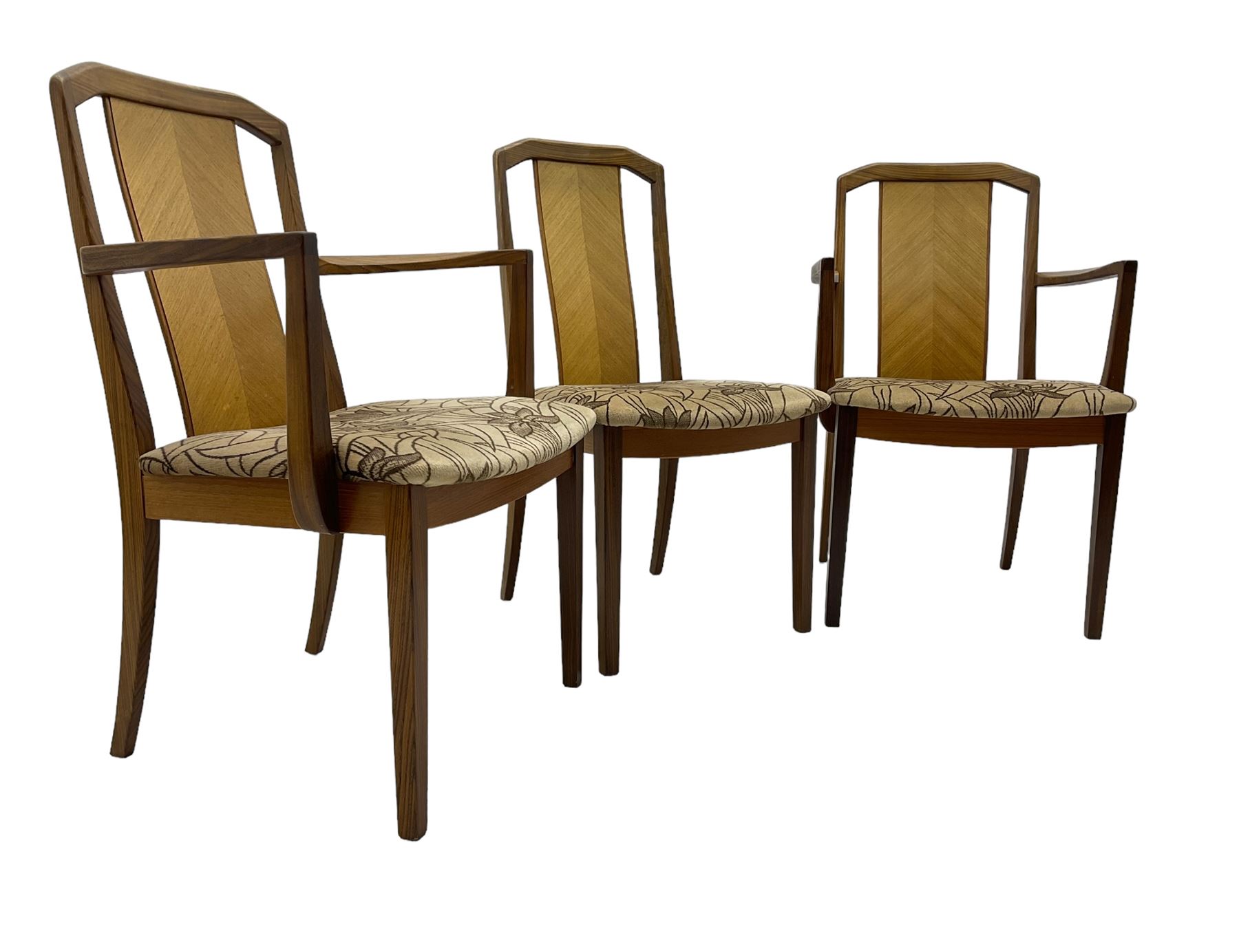 G-Plan -  1970s teak extending dining table, pull-out extending action with fold-out leaf, rectangular end supports on sledge feet united by stretcher (100cm x 160cm - 205cm, H73cm); set of six dining chairs, chevron-patterned backrests upholstered with floral patterned fabric, on tapered legs, H89cm