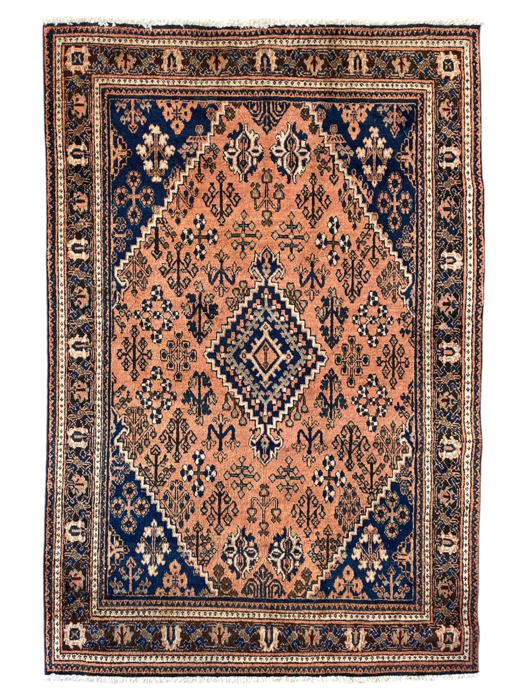 Persian Joshaghan peach and blue ground rug, central stepped lozenge medallion surrounded by bunches of floral motifs, repeating border decorated with stylised plant motifs, within multiple guard stripes