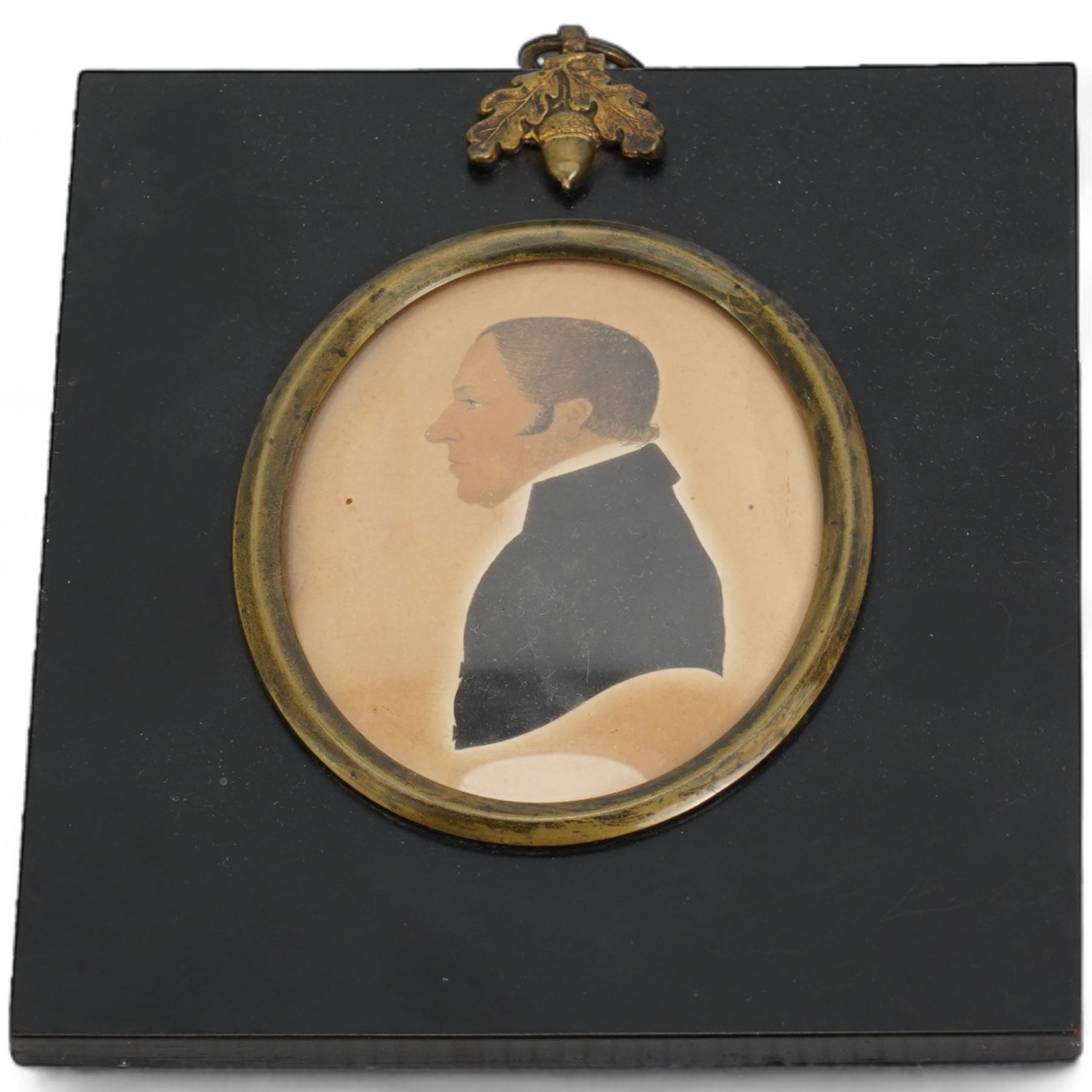 Pair of 19th century oval hand-coloured silhouettes of 'The Reverend D Isaac - Preacher of the Gospel 1859' and 'Mrs D Isaac Coningsby', in ebonised frames; together with another similar 13cm x 11cm (3)