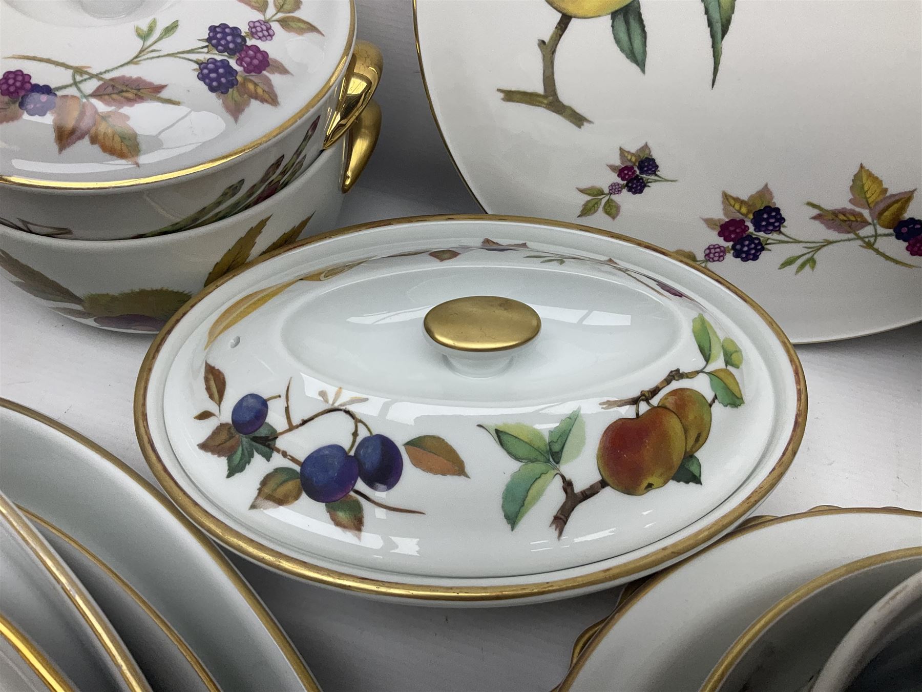 Royal Worcester Evesham pattern, including covered pot de cremes, twin handle tureen, serving dishes, flan dishes, side plates etc  