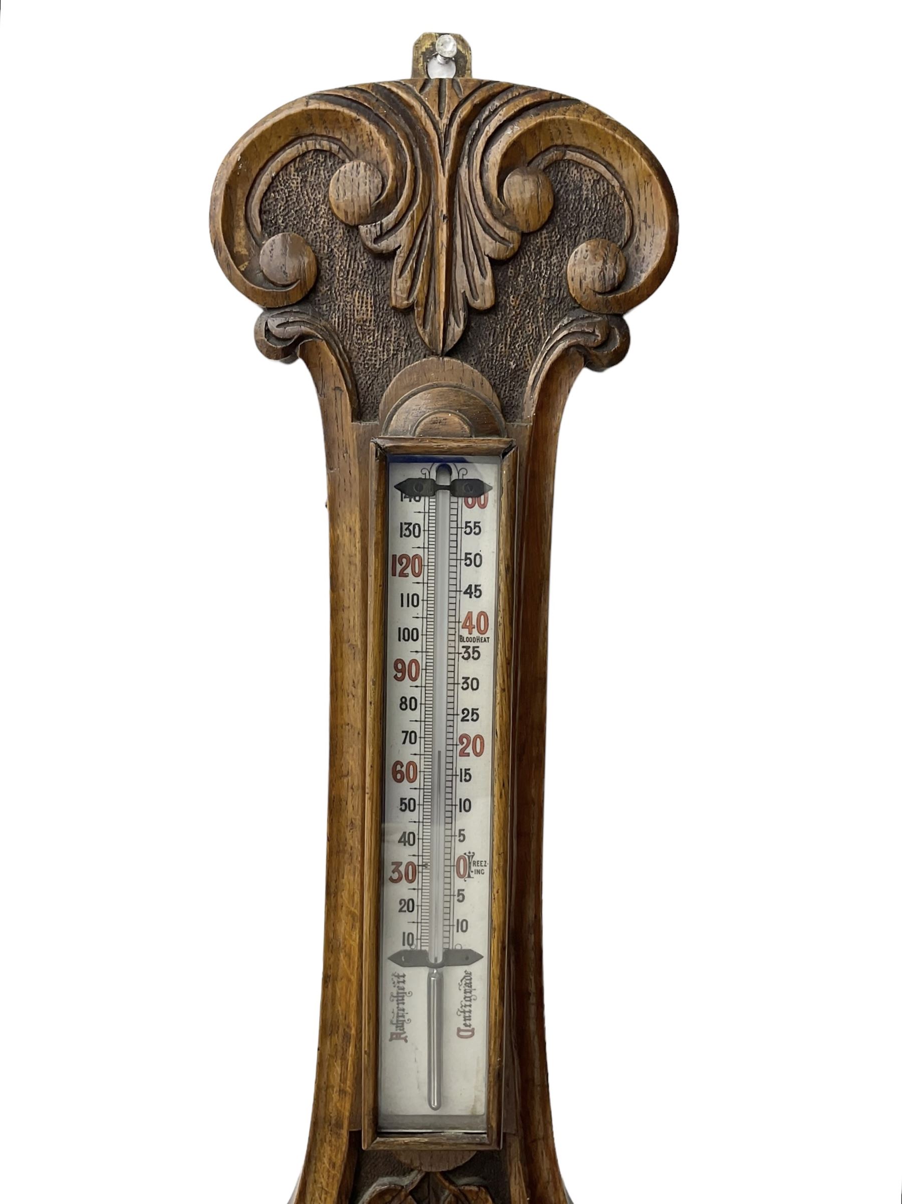 Edwardian - carved oak aneroid barometer, with a rounded top carved with scroll work, 8