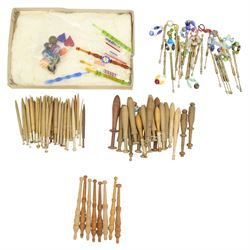 Collection of lace maker's bobbins to include ornate coloured glass examples, eight Maltese wooden bobbins, twenty brass bobbins with turned and textured shafts, together with various wooden examples, some with ornate glass beaded weights/ spangles 