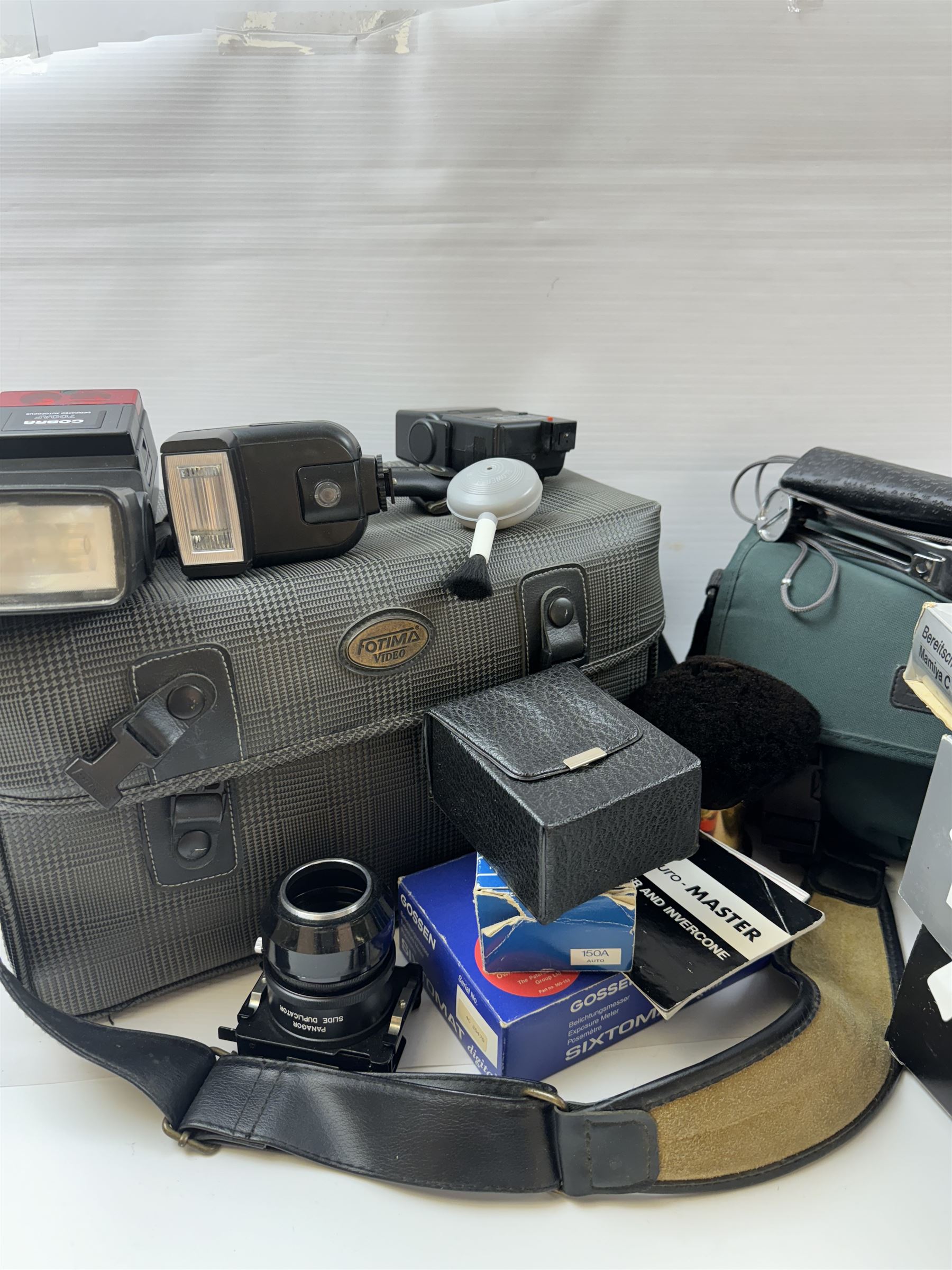 Collection of camera accessories, including Cobra 700AF flash, Weston Euro-Master exposure meter, cases, grips batteries, etc 