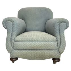 20th century traditional shape armchair, curved back and rolled arms, upholstered in light blue patterned fabric, on turned front feet