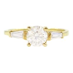 18ct gold single stone round brilliant cut diamond ring, with tapered baguette diamond shoulders, stamped 750, principal diamond approx 0.65 carat, total diamond weight approx 0.85 carat