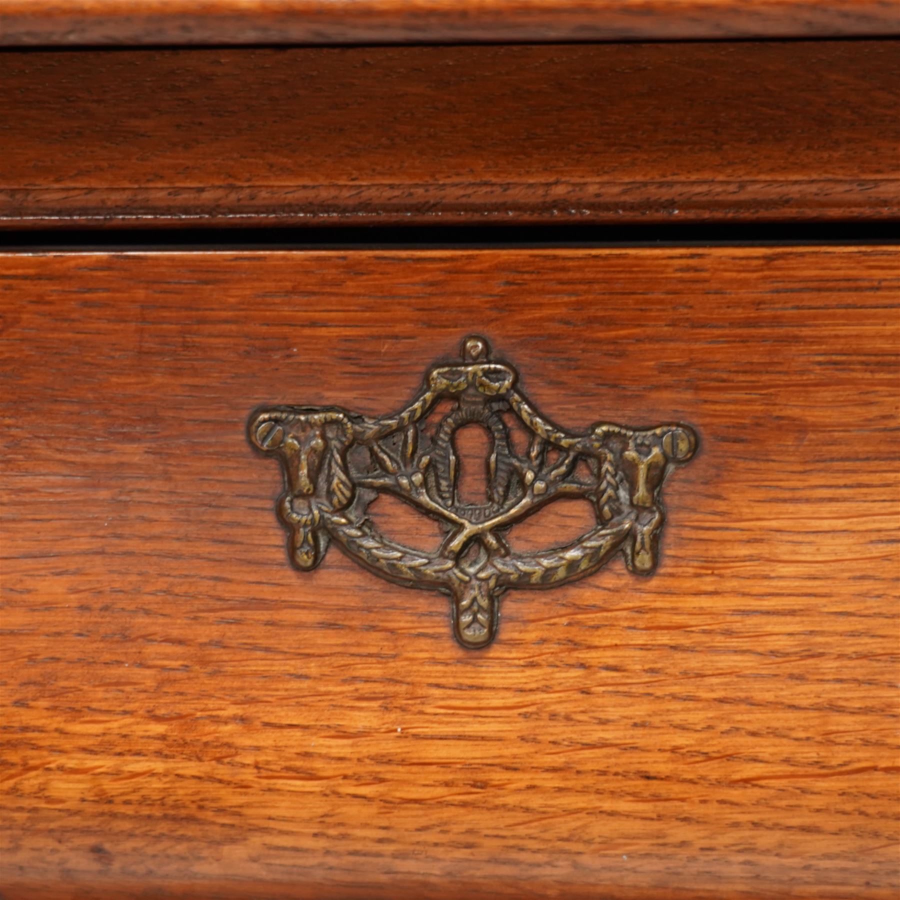 Early 20th century Dutch oak bombe chest, shaped rectangular top with moulded edge, fitted with three drawers flanked by moulded uprights, on hairy ball-and-claw feet