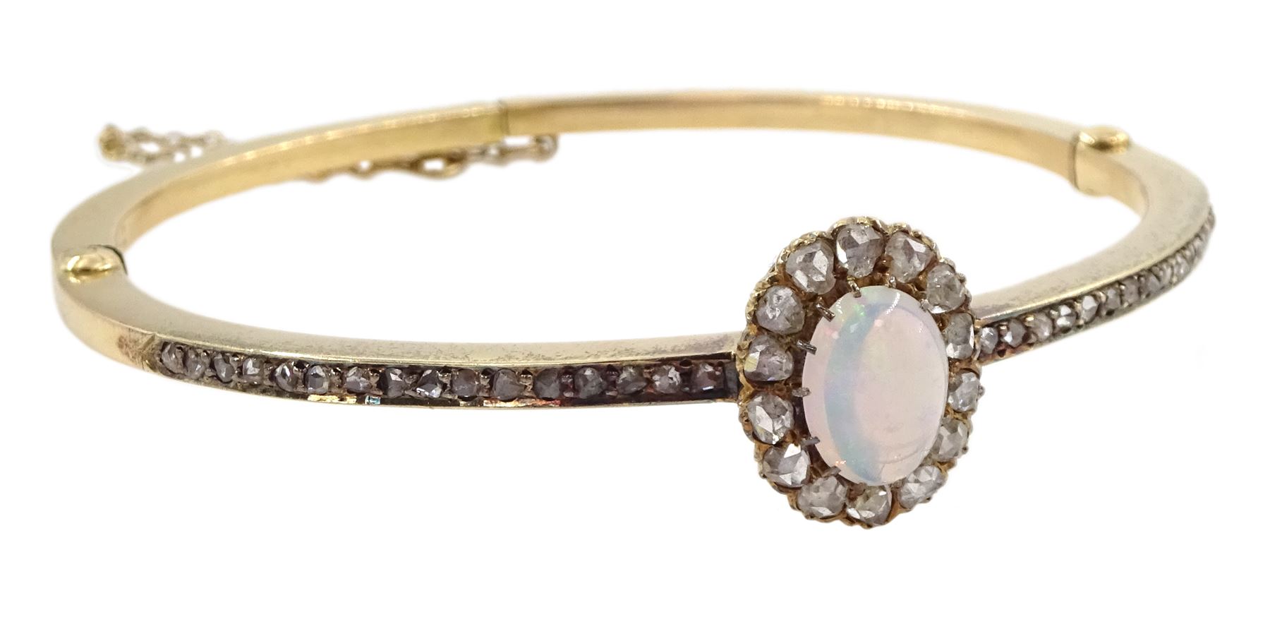 Early 20th century gold opal and diamond hinged bangle, the central opal and rose cut diamond cluster, with channel set rose cut diamonds set either side