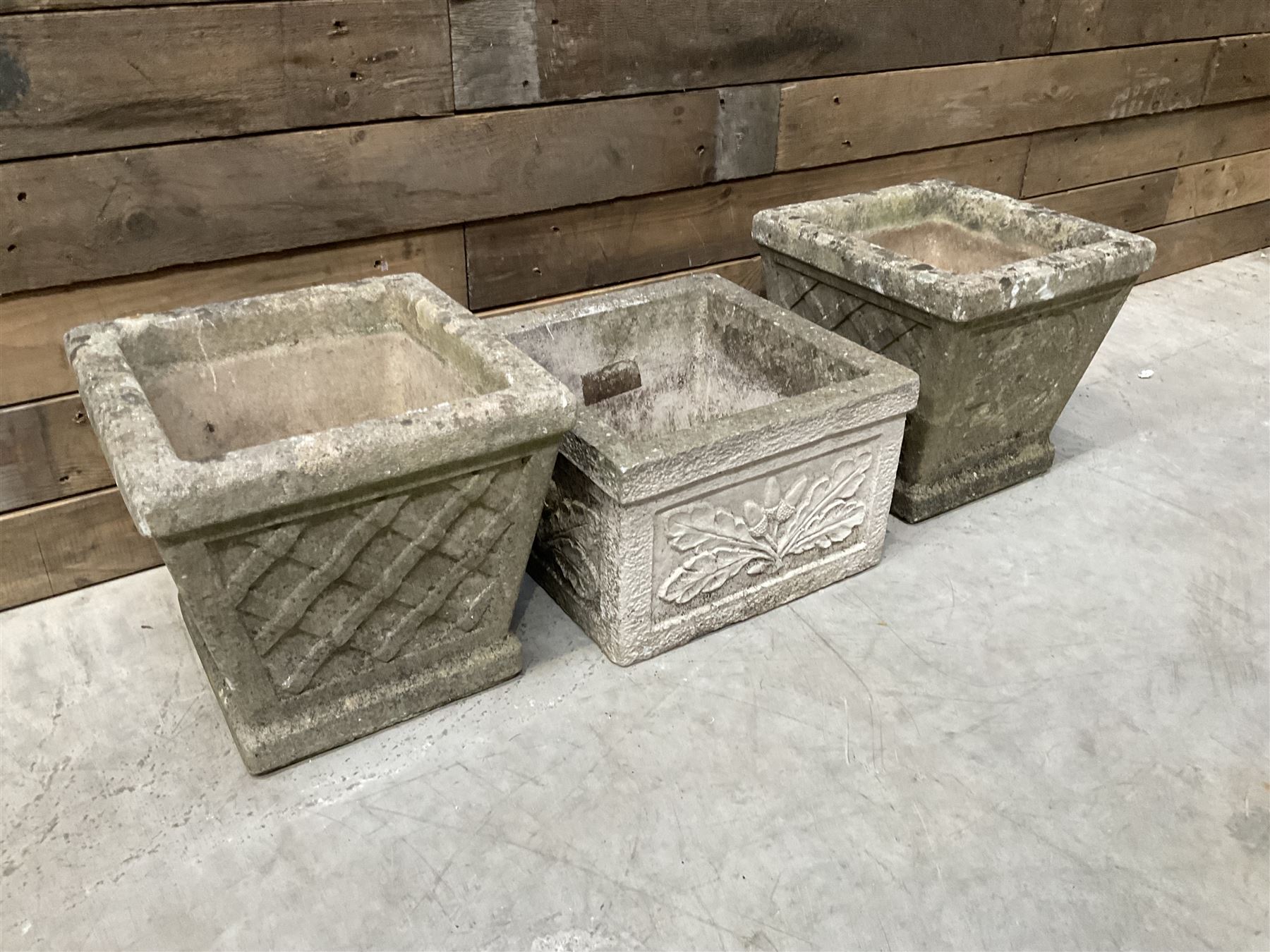 Pair of square cast stone planters, single planter with leaf decoration and a rectangular brick effect planter (4)