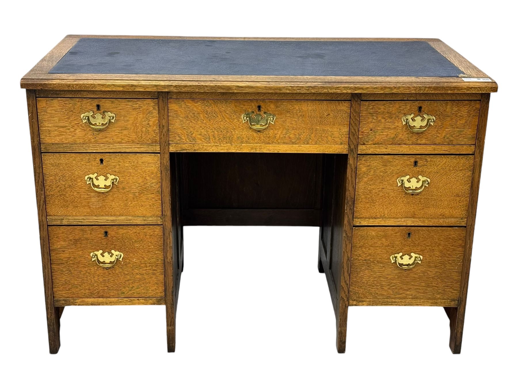 Edwardian oak twin pedestal desk, moulded rectangular top with inset writing surface, fitted with seven drawers, panelled sides, on stile supports 