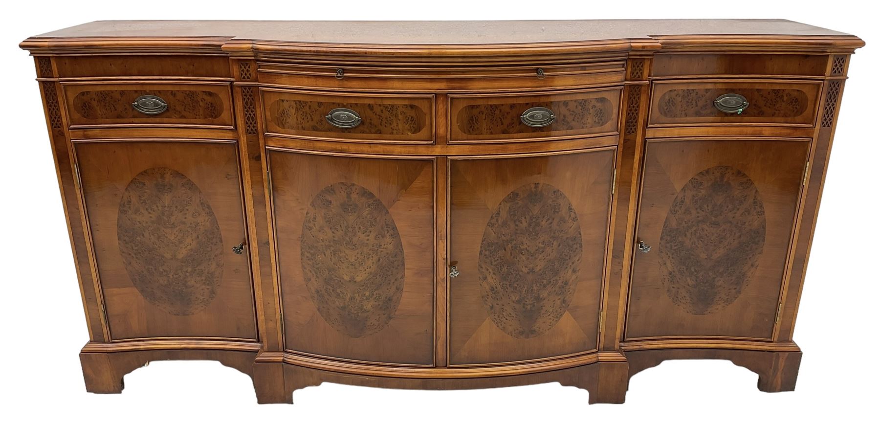 Wade - Georgian design yew wood bow-fronted sideboard, projecting moulded top over four cockbeaded frieze drawers, the central two with pull-out slides, four cupboards below with figured veneers, raised on bracket feet