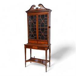 Early 19th century mahogany and satinwood bookcase on stand, scrolled swan neck pediment w...