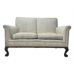 Early 20th century mahogany framed two-seat sofa, upholstered in pale fabric decorated with scrolling foliage, on acanthus carved ball and claw cabriole feet 