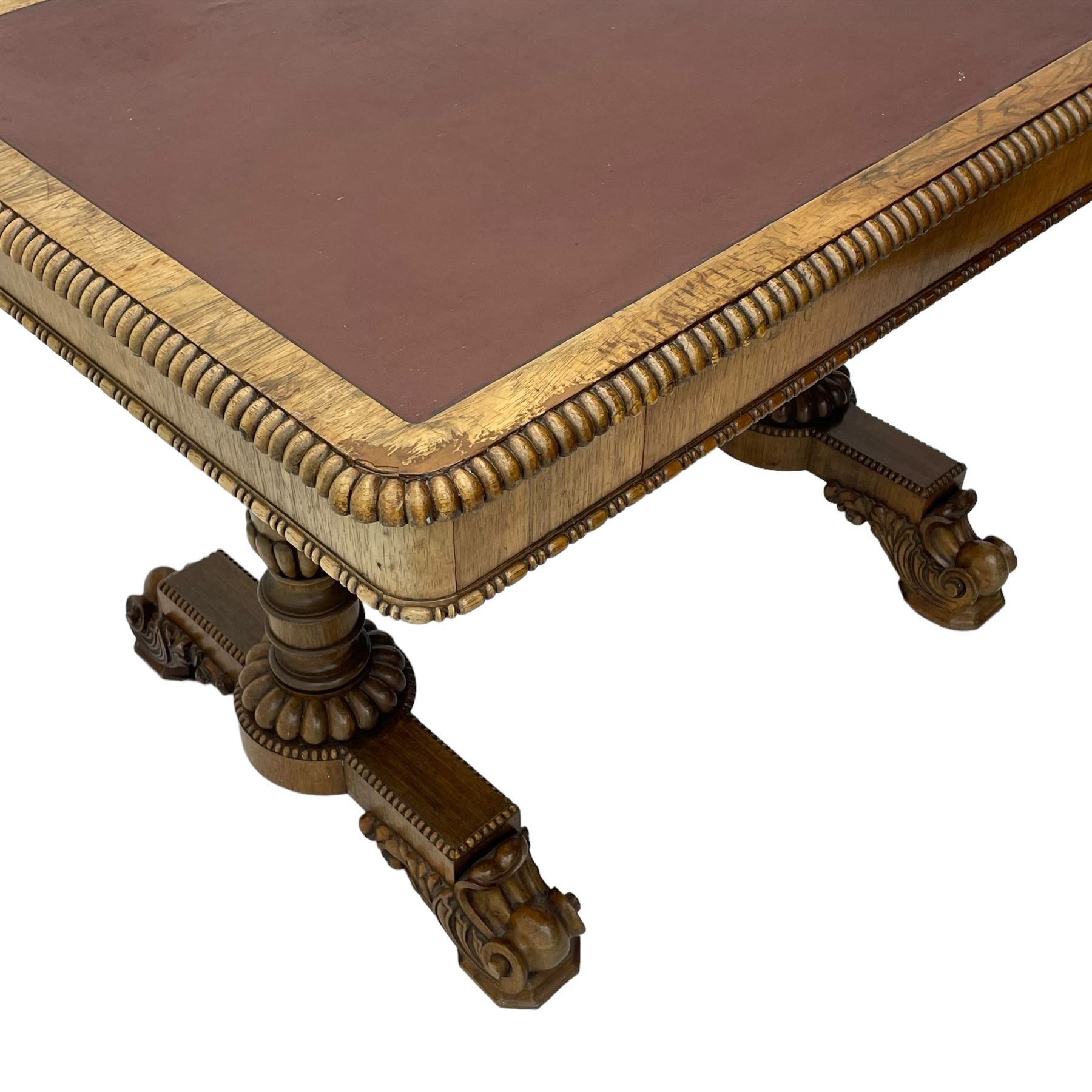 Early 19th century Regency rosewood writing table, rectangular top with inset leather writing surface and gadroon moulded edge, fitted with single frieze drawer, on twin turned pillar supports with lobe carved balusters, on platforms with beaded edge, acanthus scroll carved feet