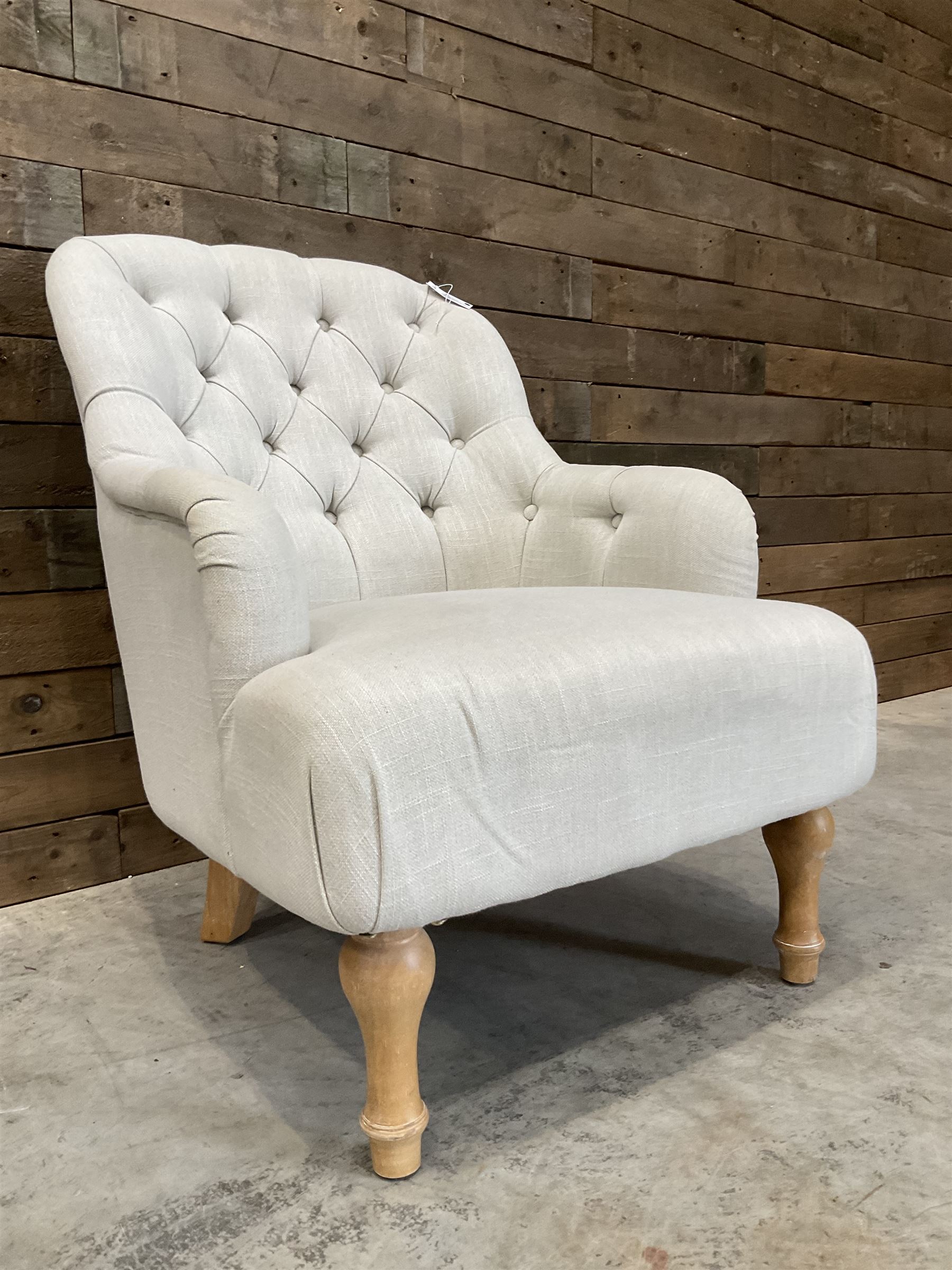 Armchair upholstered in button back linen fabric