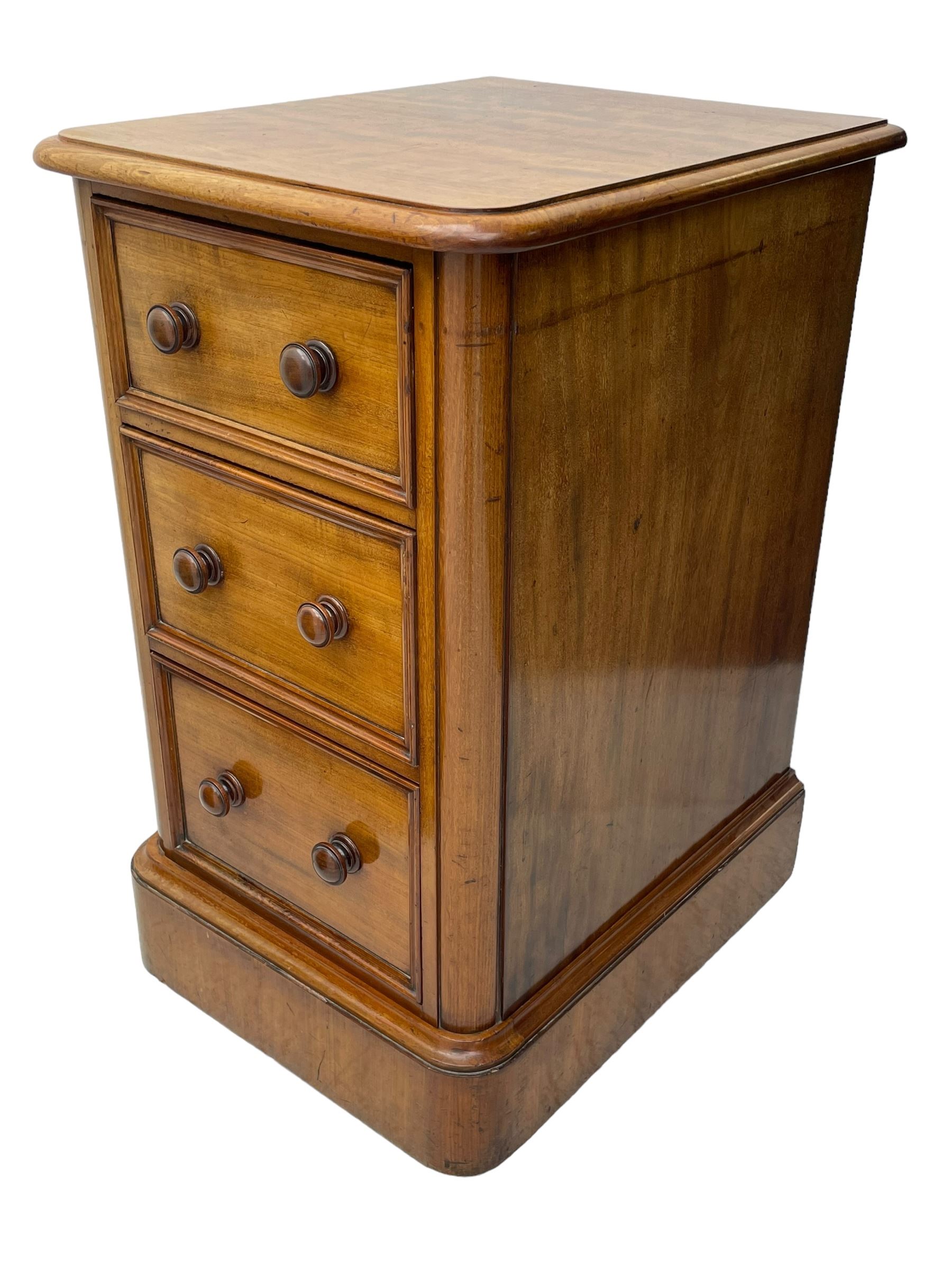 Pair of Victorian figured mahogany pedestal chests, rectangular form with rounded front corners, moulded top over three drawers with applied mouldings and turned handles, on moulded plinth base