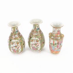 Pair of 20th century famille rose vases, of baluster form with fluted rim, the panels deco...