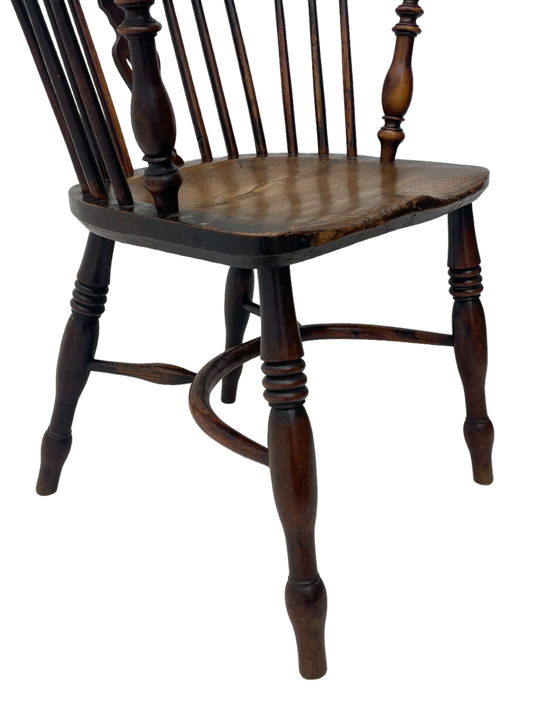 19th century yew wood and elm Windsor armchair, low double hoop stick and pierced splat back, dished seat on turned supports united by crinoline stretchers